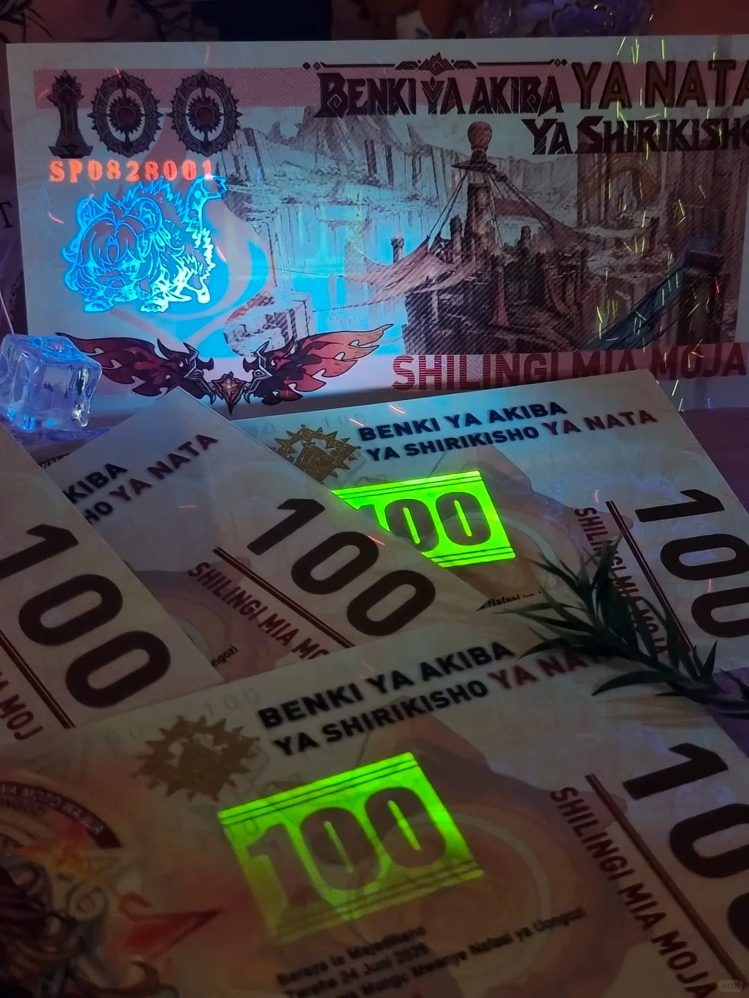 Multiple Mavuika collector notes with the luminescent green UV security feature and color-shifting Shilingi Mia Moja