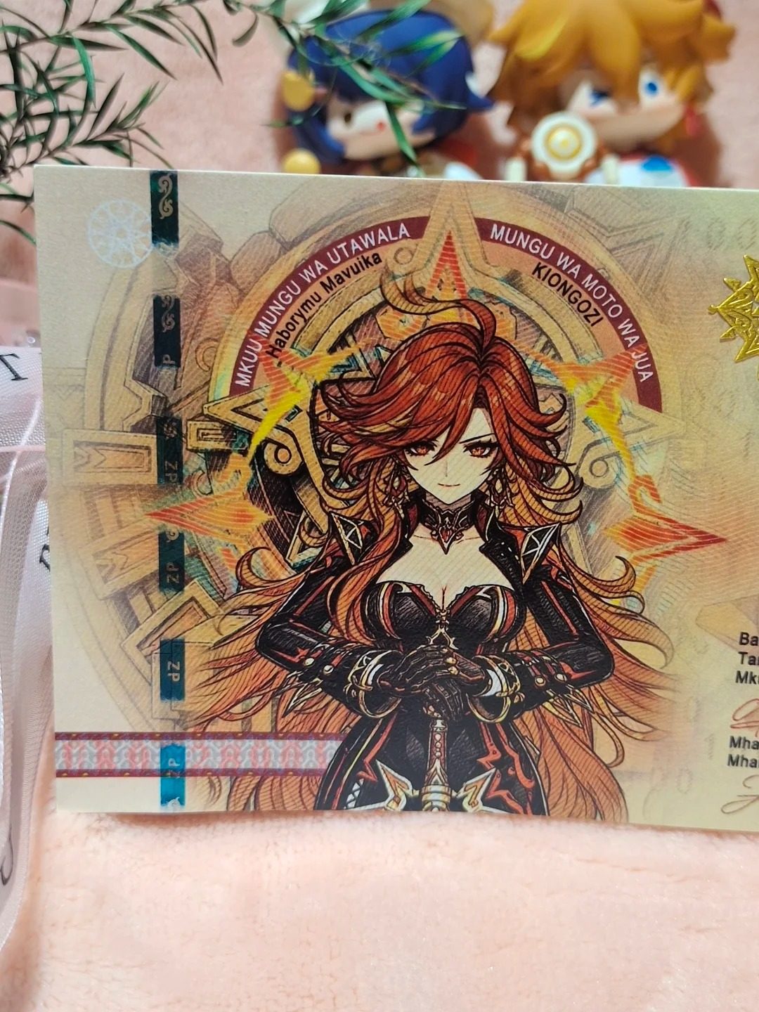 Mavuika collector note front detail, hand-drawn Pyro Archon of Natlan with signature and metallic lettering
